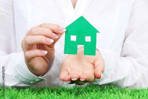 Photo: concept: woman hands with paper house, close up concept: woman hands with paper house, close up