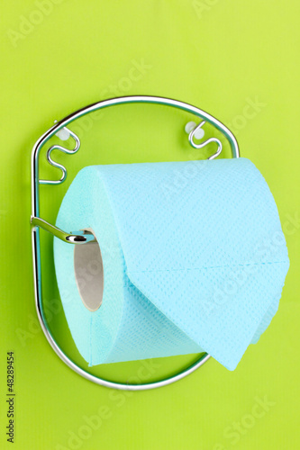 Photo: Roll of toilet paper on holder fixed to wall Roll of toilet paper on holder fixed to wall