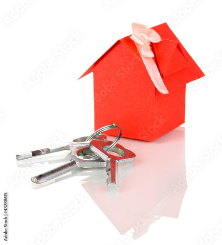 Photo: Small house with key isolated on white Small house with key isolated on white