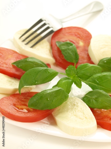 Photo: Portion of caprese, closeup, isolated Portion of caprese, closeup, isolated