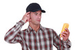 Puzzled tradesman staring at his multimeter