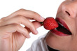 Woman eating strawberry