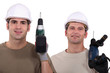 duo of electricians holding drill
