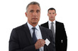 Company CEO removing business card from pocket