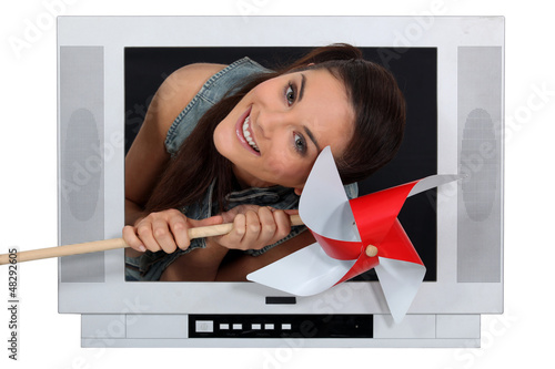 Photo: Woman coming out from TV with a grinder Woman coming out from TV with a grinder