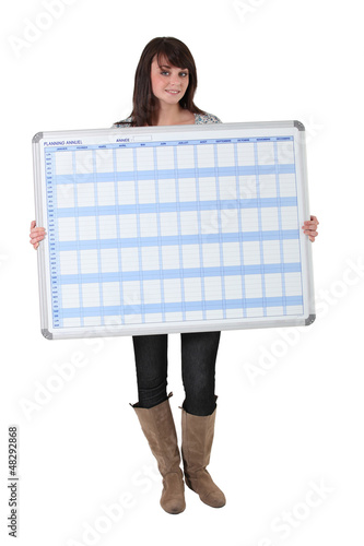 Photo: Young woman with a planning board Young woman with a planning board