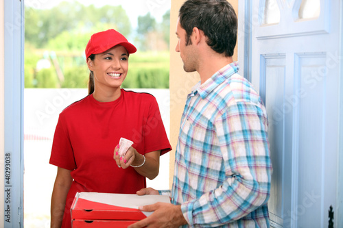 Photo: Woman delivering pizza Woman delivering pizza