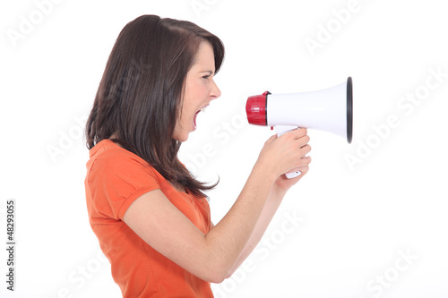 Photo: young woman shouting through a megaphone young woman shouting through a megaphone