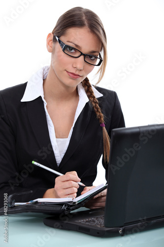 Photo: Businesswoman writing in her agenda Businesswoman writing in her agenda
