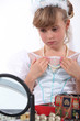 Girl dressed as a princess trying on necklace