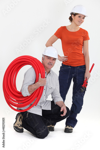 Photo: plumber and young apprentice posing plumber and young apprentice posing