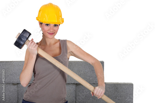 Photo: female bricklayer holding hammer female bricklayer holding hammer