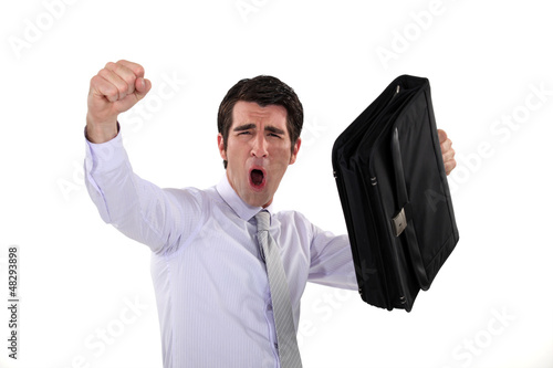 Photo: happy businessman raising his briefcase and fist happy businessman raising his briefcase and fist