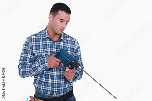 Photo: Man holding drill with long extension Man holding drill with long extension