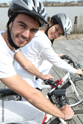 Photo: Young couple cycling Young couple cycling