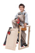 Young boy pretending to be an adult carpenter