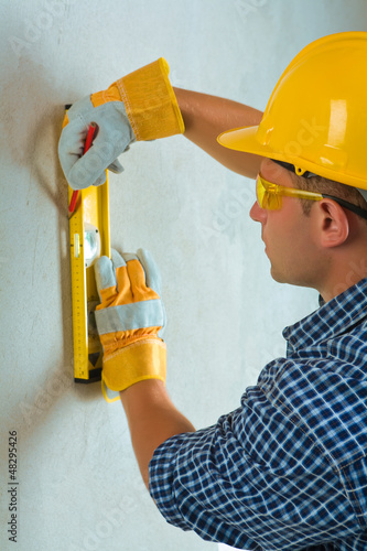 Photo: a worker layering on cocrette wall a worker layering on cocrette wall