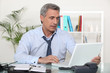 mature businessman working on his desk