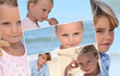 Foto: Montage of children on a beach Montage of children on a beach