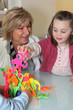 Woman watching her granddaughter playing a game