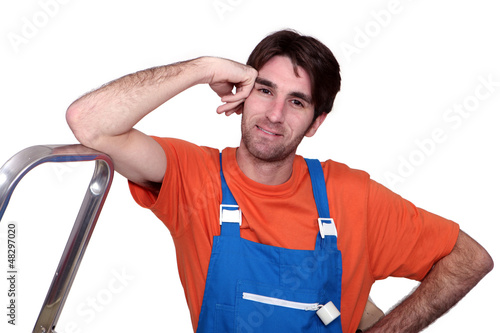 Photo: Tradesman leaning against a stepladder Tradesman leaning against a stepladder