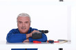 Man with his tools leaning on a shelf