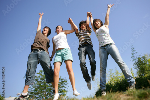 Photo: Happy teenagers jumping in air Happy teenagers jumping in air