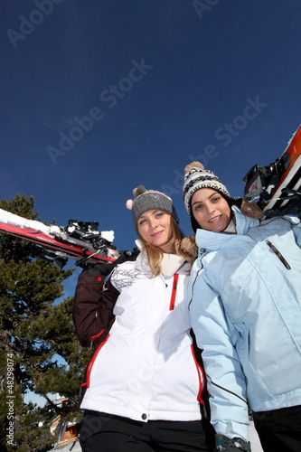 Photo: Two female friends skiing Two female friends skiing
