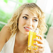 Happy woman drinking juice