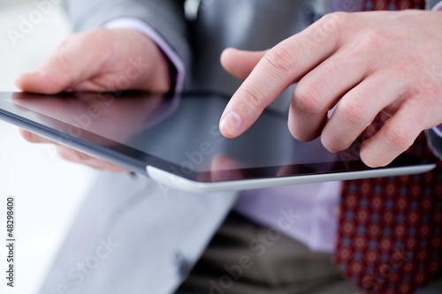 Photo: Male hands touching digital tablet Male hands touching digital tablet