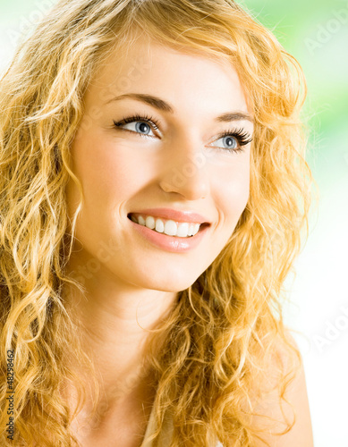 Photo: Smiling young beautiful woman, indoors Smiling young beautiful woman, indoors