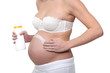 Pregnant woman putting cream on her belly