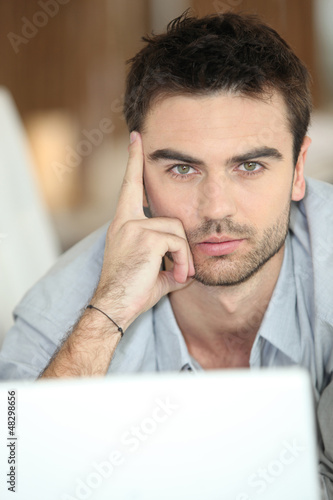 Photo: Relaxed man using laptop Relaxed man using laptop
