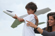 Photo: Mother and son playing with a large model toy aeroplane Mother and son playing with a large model toy aeroplane
