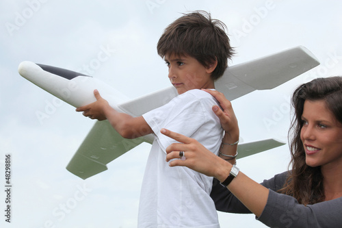 Photo: Mother and son playing with a large model toy aeroplane Mother and son playing with a large model toy aeroplane