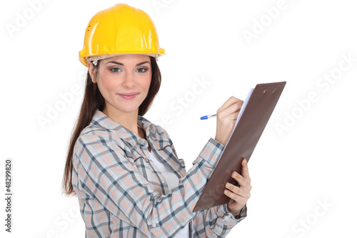 Photo: Female construction worker with a clipboard Female construction worker with a clipboard