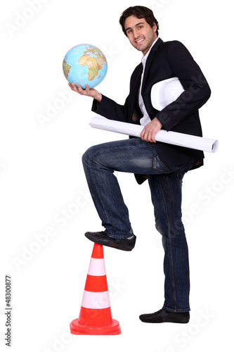 Photo: Architect holding earth. Architect holding earth.