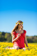Photo: Girl in spring on a flower meadow with dandelion Girl in spring on a flower meadow with dandelion