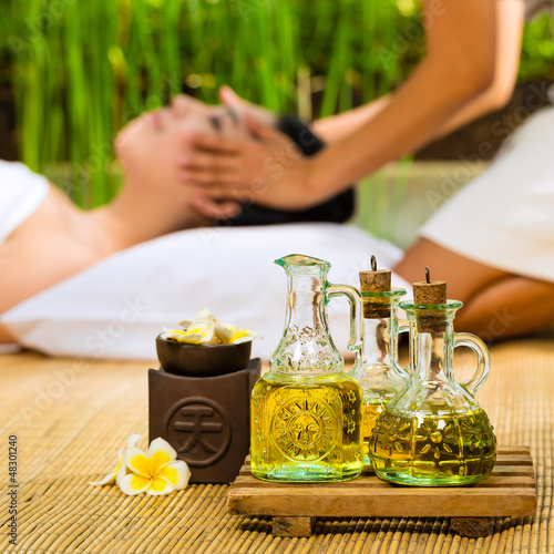 Photo: Asian woman having a massage in tropical setting Asian woman having a massage in tropical setting