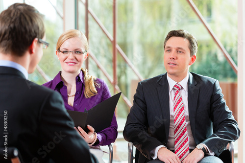 Photo: Man having an interview with manager and partner employment job Man having an interview with manager and partner employment job