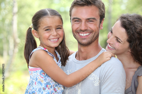 Photo: Young family stood in garden Young family stood in garden