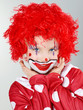 Beautiful child as a funny clown with red hair