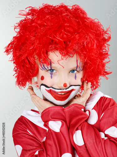 Photo: Beautiful child as a funny clown with red hair Beautiful child as a funny clown with red hair