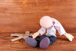 Photo: Wooden puppet sitting on wooden background Wooden puppet sitting on wooden background