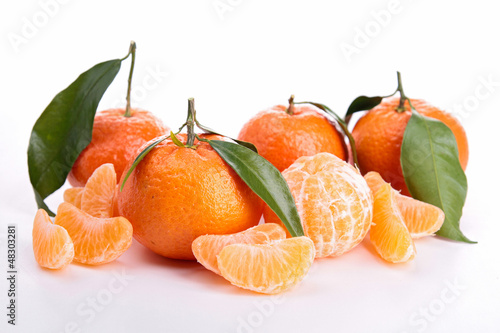 Photo: Ripe sweet tangerine isolated on white Ripe sweet tangerine isolated on white