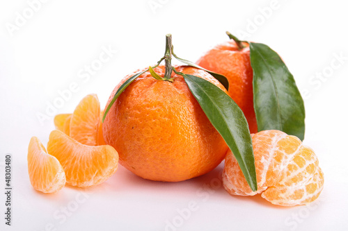 Photo: Ripe sweet tangerine isolated on white Ripe sweet tangerine isolated on white