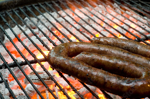Photo: Tradtional South African braai barbecue borewors sausage on fire Tradtional South African braai barbecue borewors sausage on fire
