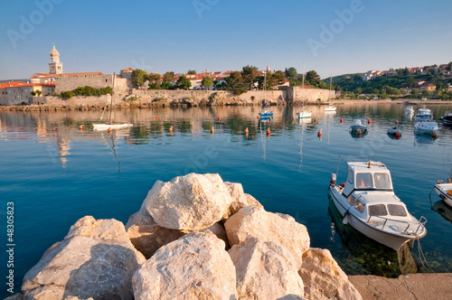Photo: Stones and boat on little port beside old town Krk - Croatia Stones and boat on little port beside old town Krk - Croatia