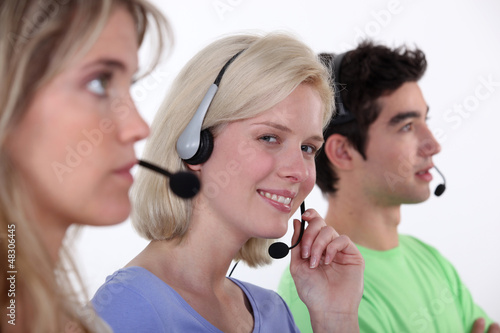 Photo: people working in a call center people working in a call center