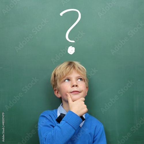 Photo: Child at the Blackboard with question Mark Child at the Blackboard with question Mark